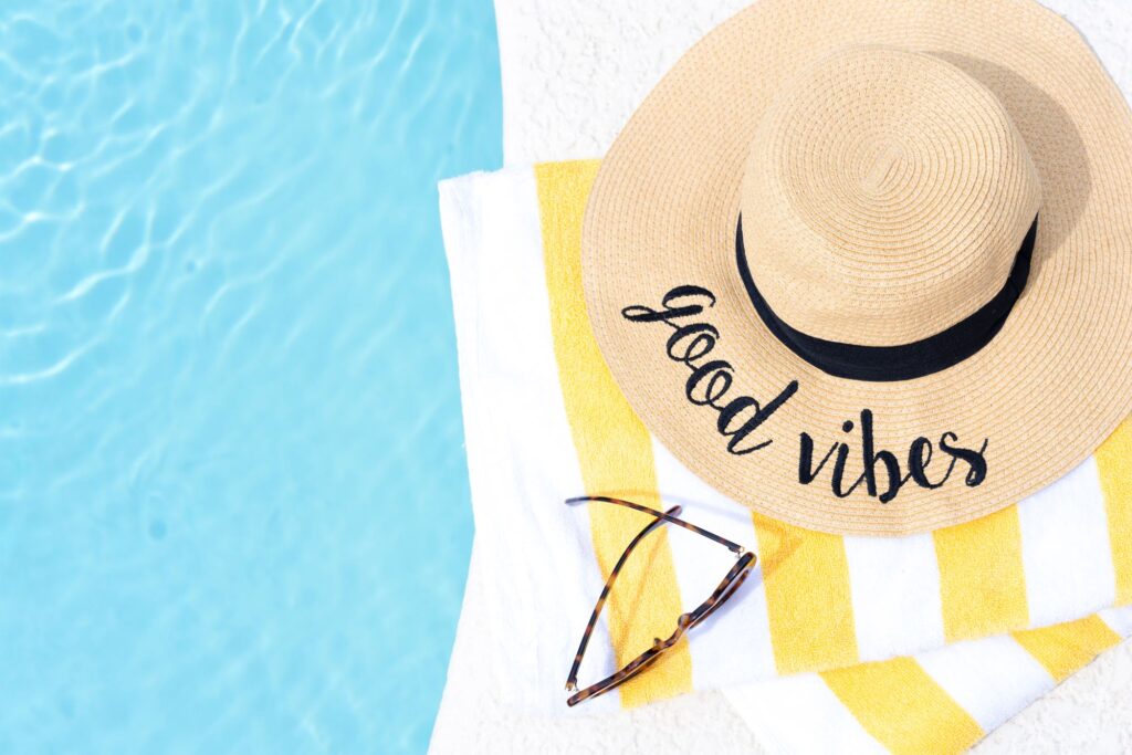 Poolside fun with a hat, sunglasses, and beach towel