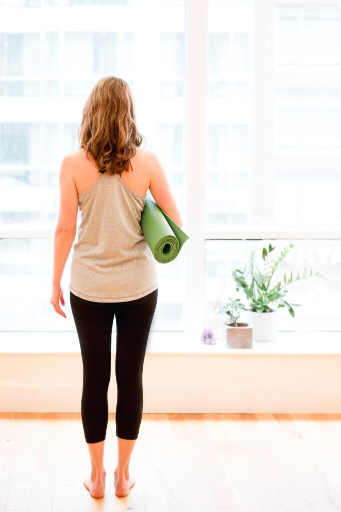 Woman holding yoga mat