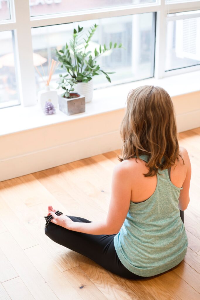 Woman meditating in a bright studio